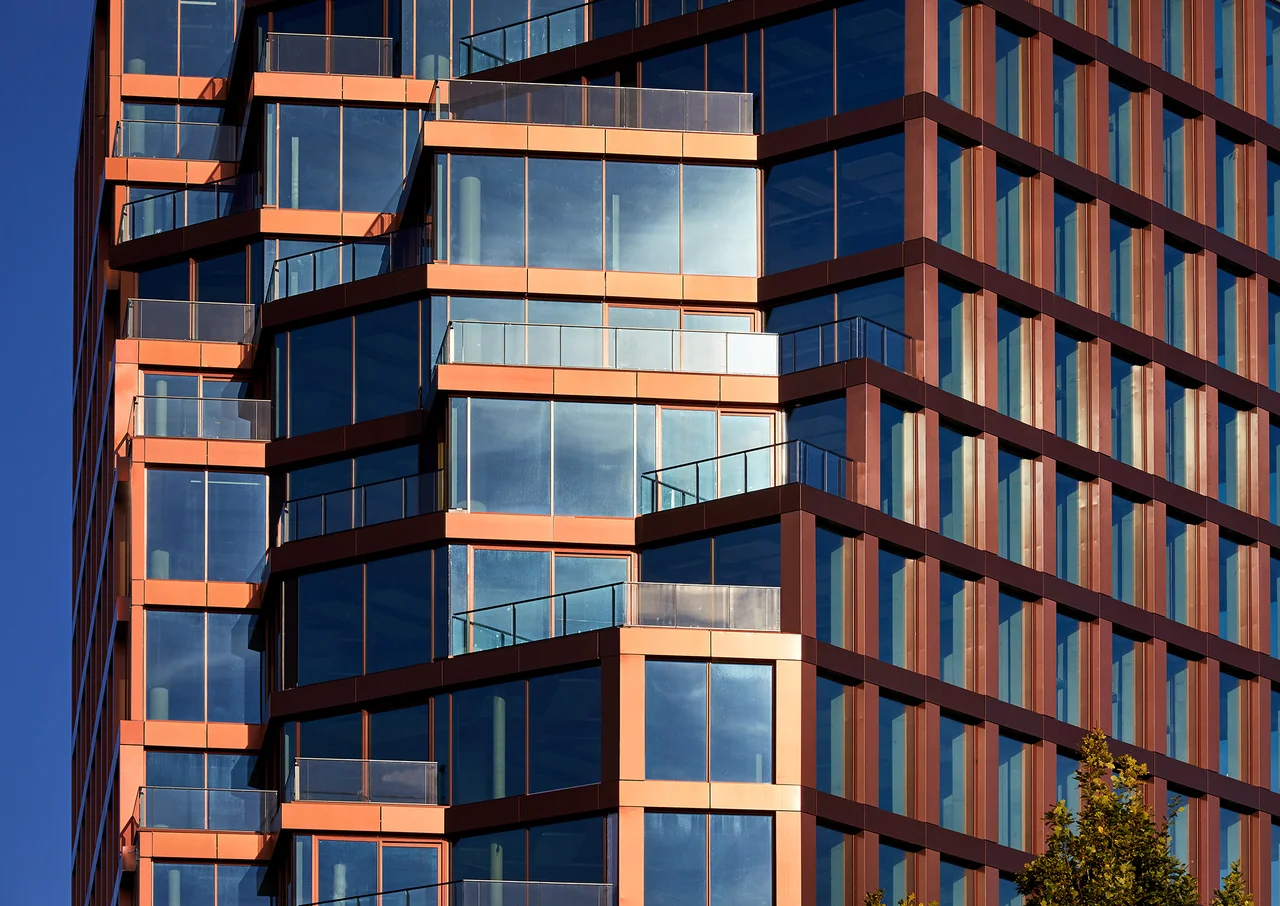 Copper terraces and floor-to-ceiling windows on the Orato facade